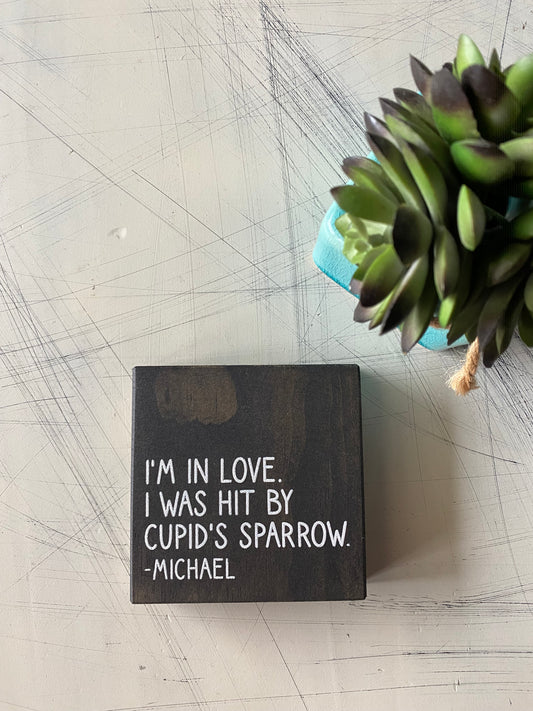 I'm in love. I was hit by cupid's sparrow. - Michael - Novotny Designs mini wood sign in black