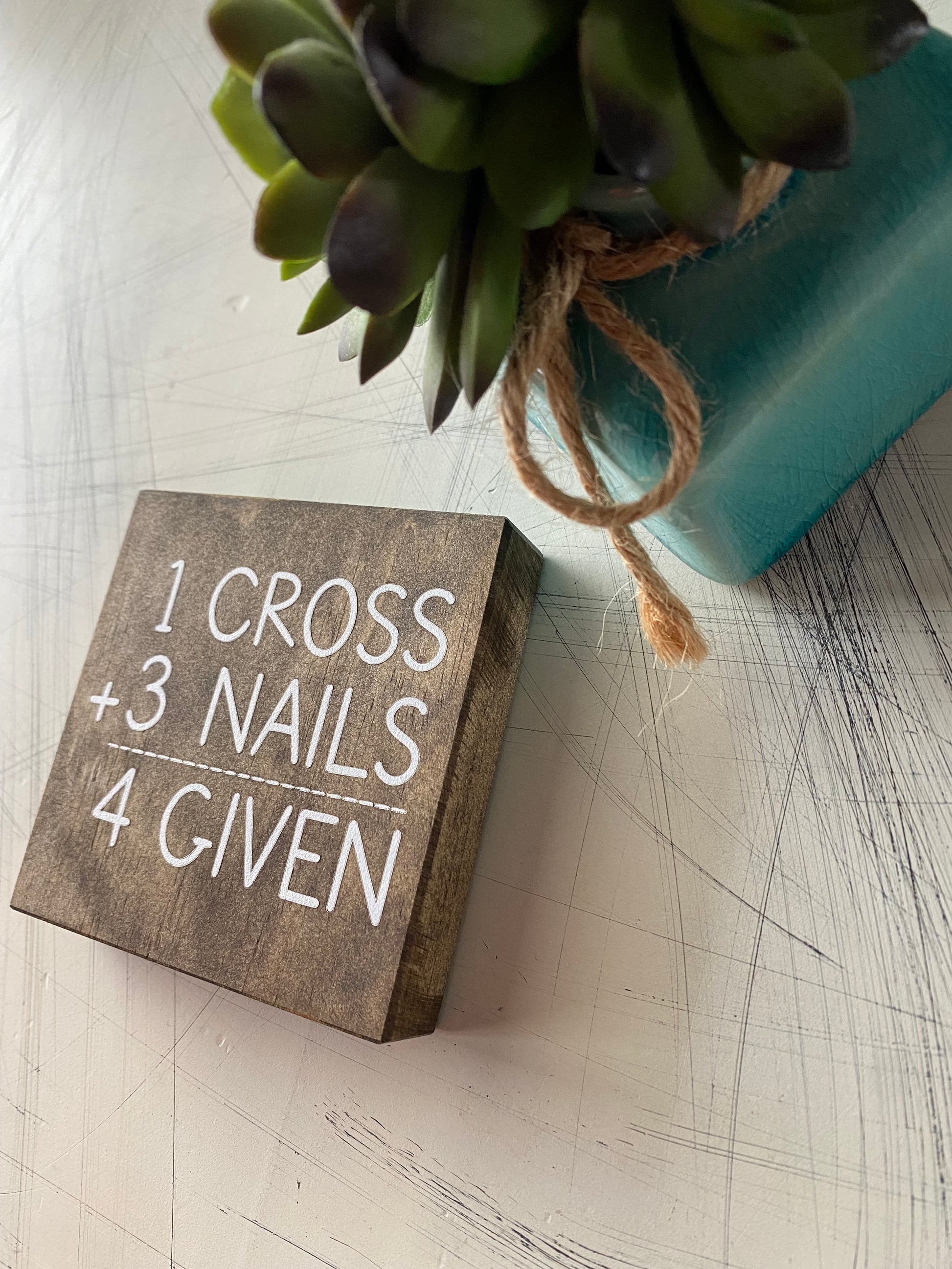 1 cross + 3 nails = 4 given . Novotny Designs mini wood sign