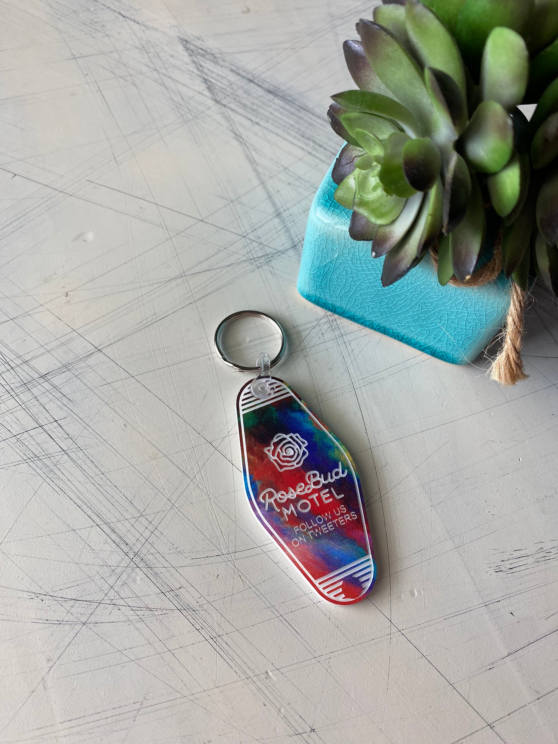 Rosebud Motel - follow us on tweeters - Novotny Designs rainbow acrylic motel-style keychain