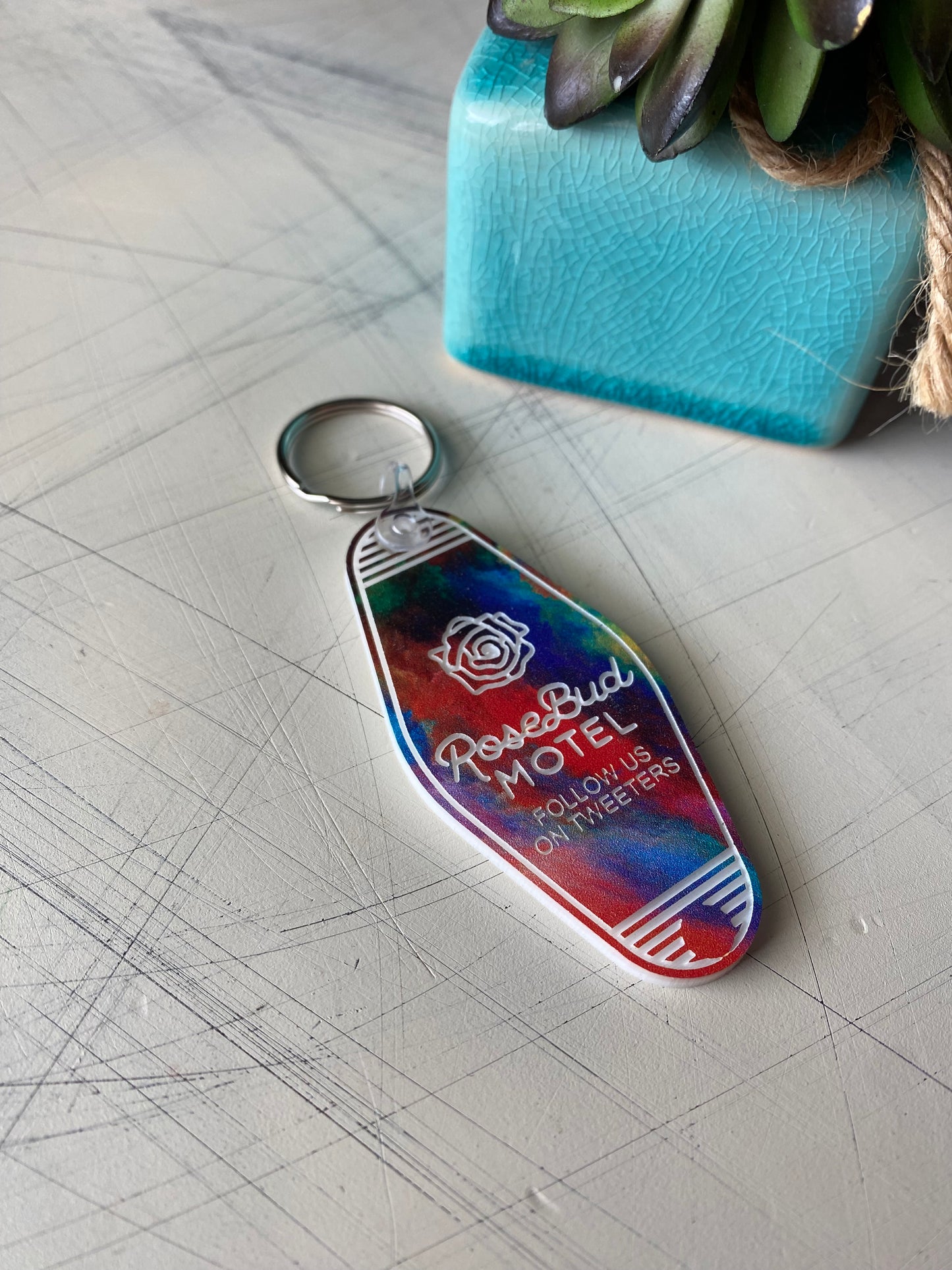 Rosebud Motel - follow us on tweeters - Novotny Designs rainbow acrylic motel-style keychain