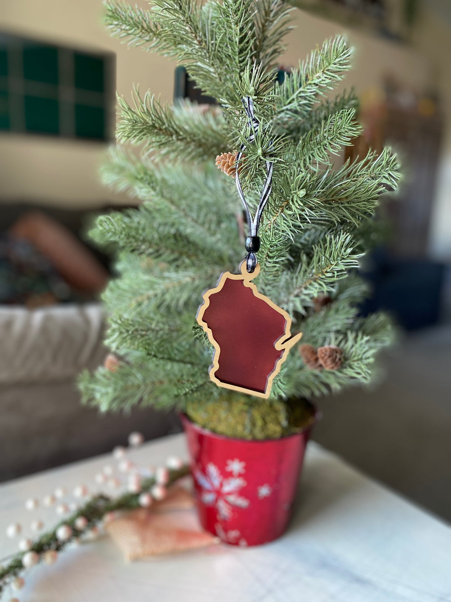 Wisconsin-shaped transparent ornament with buffalo plaid ribbon - Novotny Designs