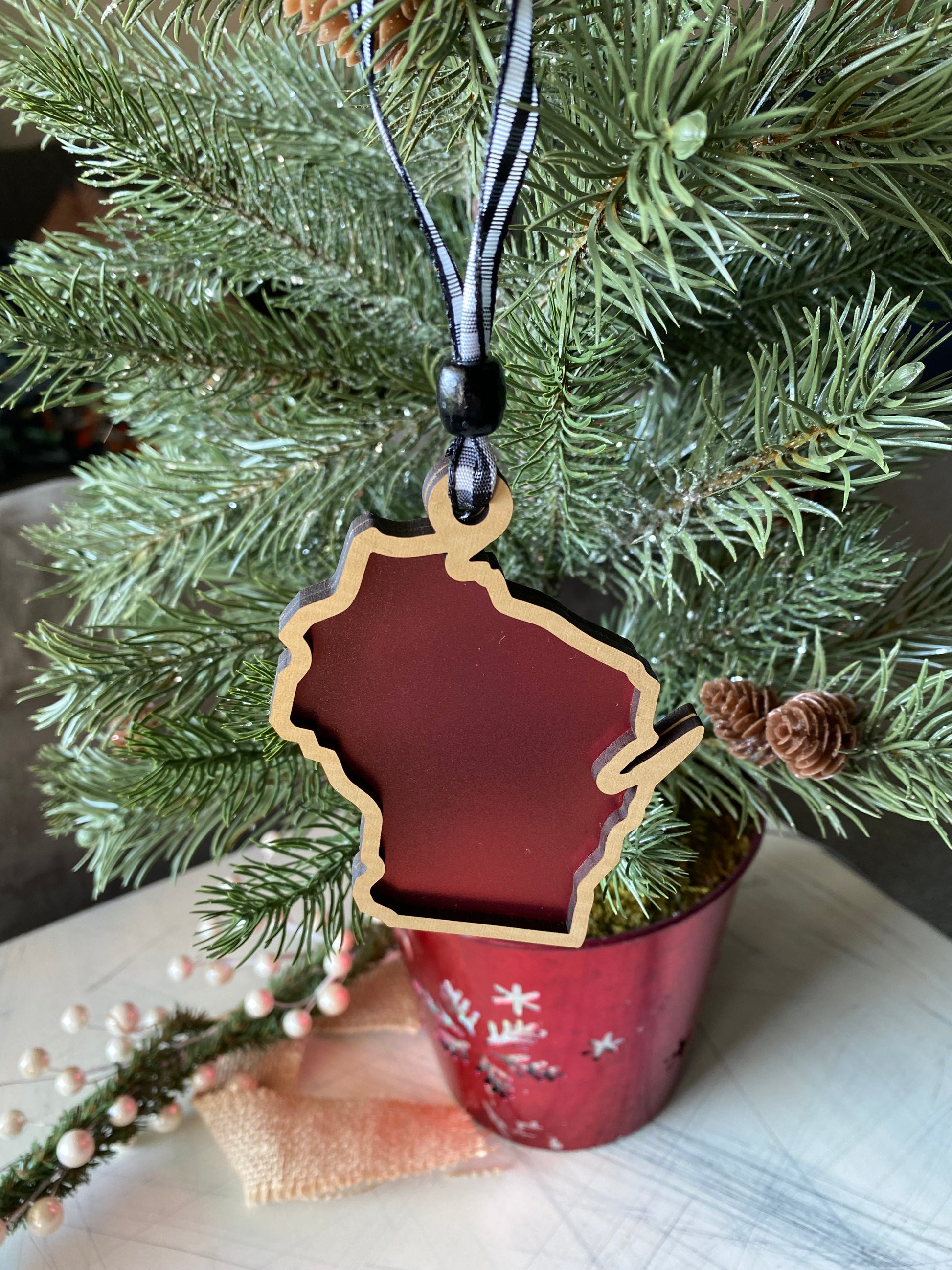 Wisconsin-shaped transparent ornament with buffalo plaid ribbon - Novotny Designs