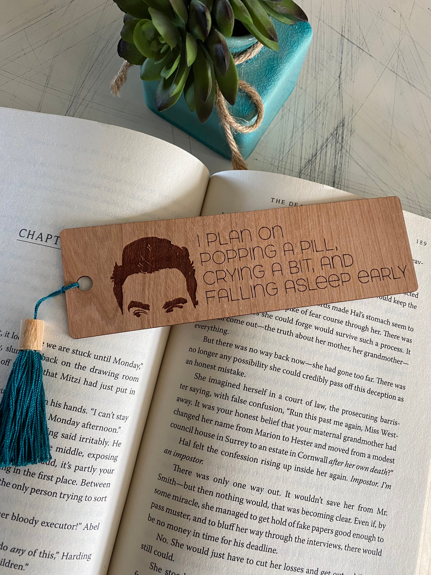 I plan on popping a pill, crying a bit, and falling asleep early. - engraved wood bookmark